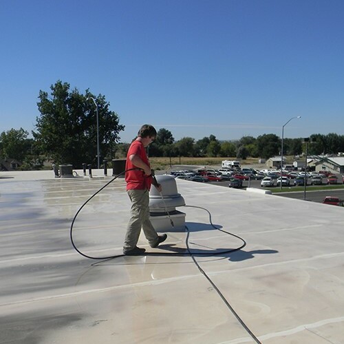 A Contractor Applies a Roof Coating.